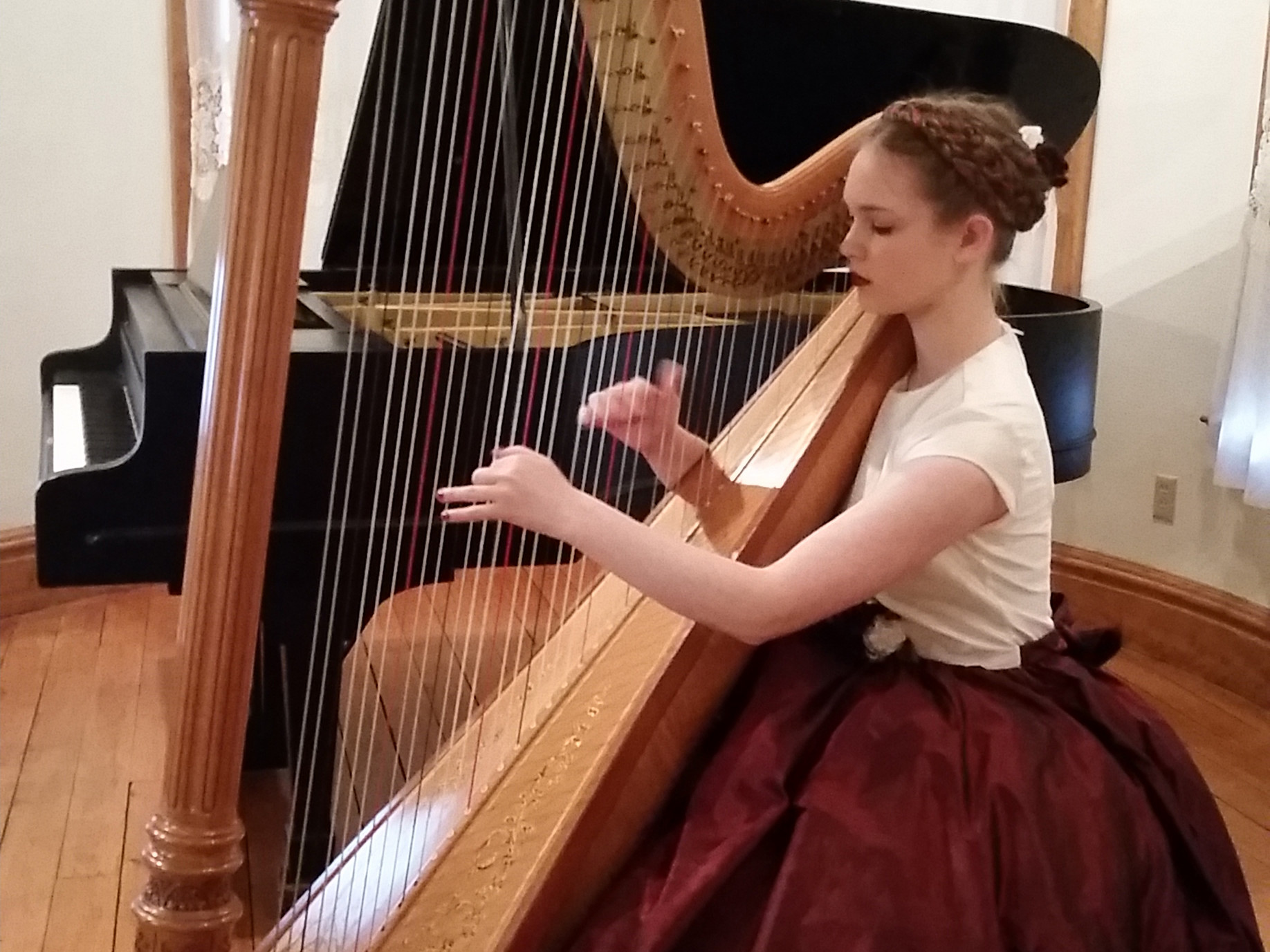 Photo of Rebecca playing her harp