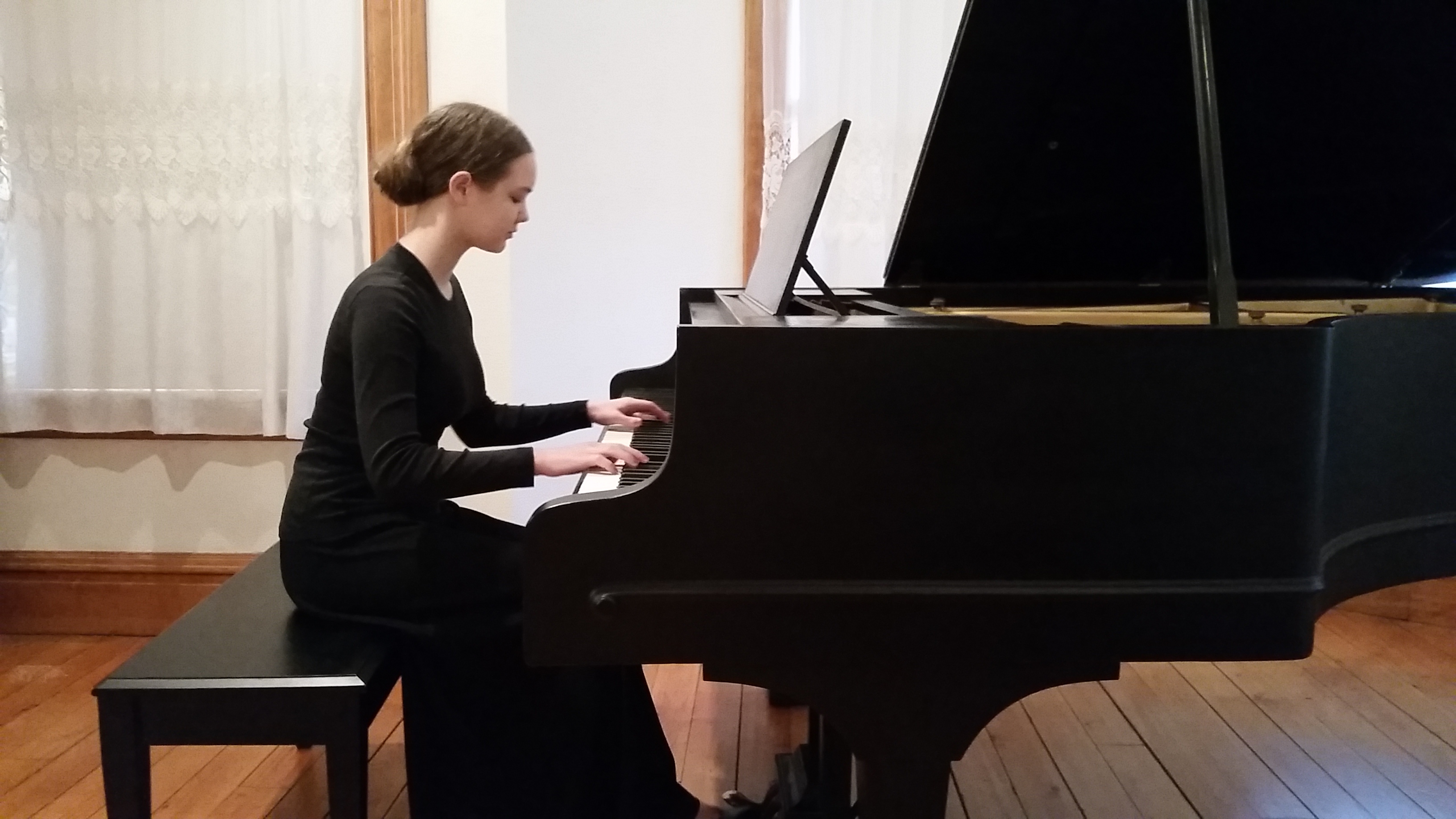 Photo of Rebecca playing piano